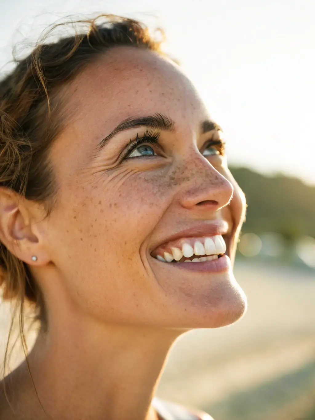 A person with a bright, genuine smile, symbolizing increased happiness and emotional well-being through stressor therapy.